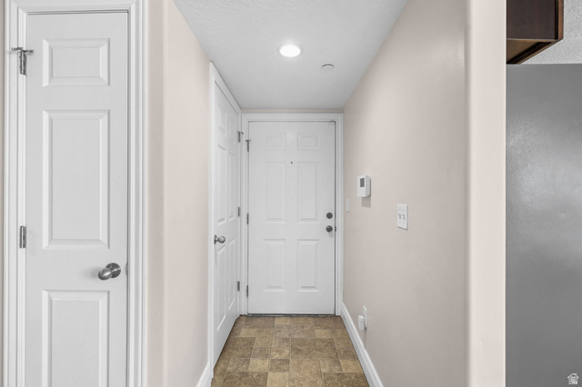 8264 South Resaca Drive, Unit K3 Sandy, UT 84070 - Photo 4 of 30 Entryway featuring a paneled door, recessed lighting, and neutral wall paint