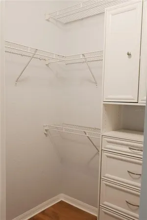 a white toilet sitting next to a white wall