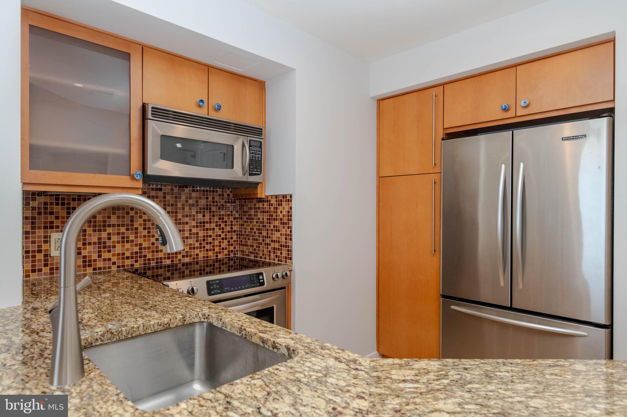675 President Street, Unit 2207 Baltimore, MD 21202 - Photo 7 of 30 a kitchen with stainless steel appliances granite countertop a refrigerator and a stove top oven