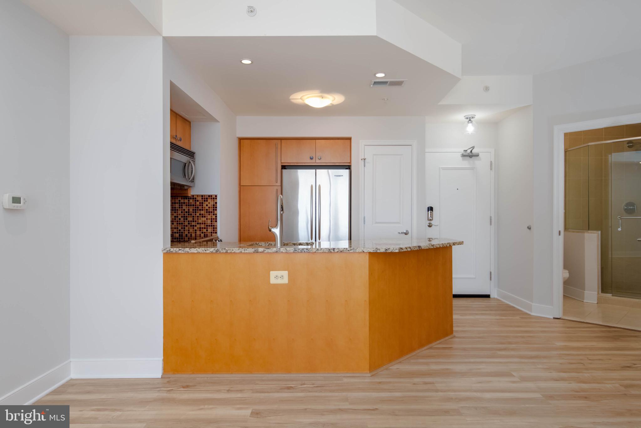 675 President Street, Unit 2207 Baltimore, MD 21202 - Photo 8 of 30 a view of kitchen and hall with wooden floor
