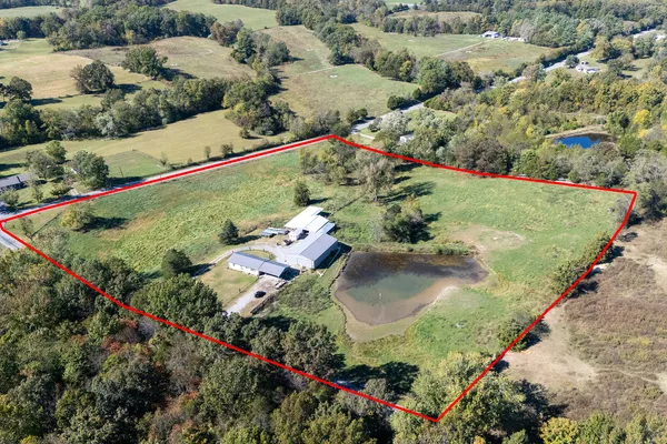 an aerial view of residential house with outdoor space and parking