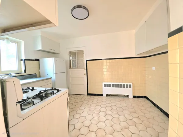 a kitchen with a stove and a refrigerator