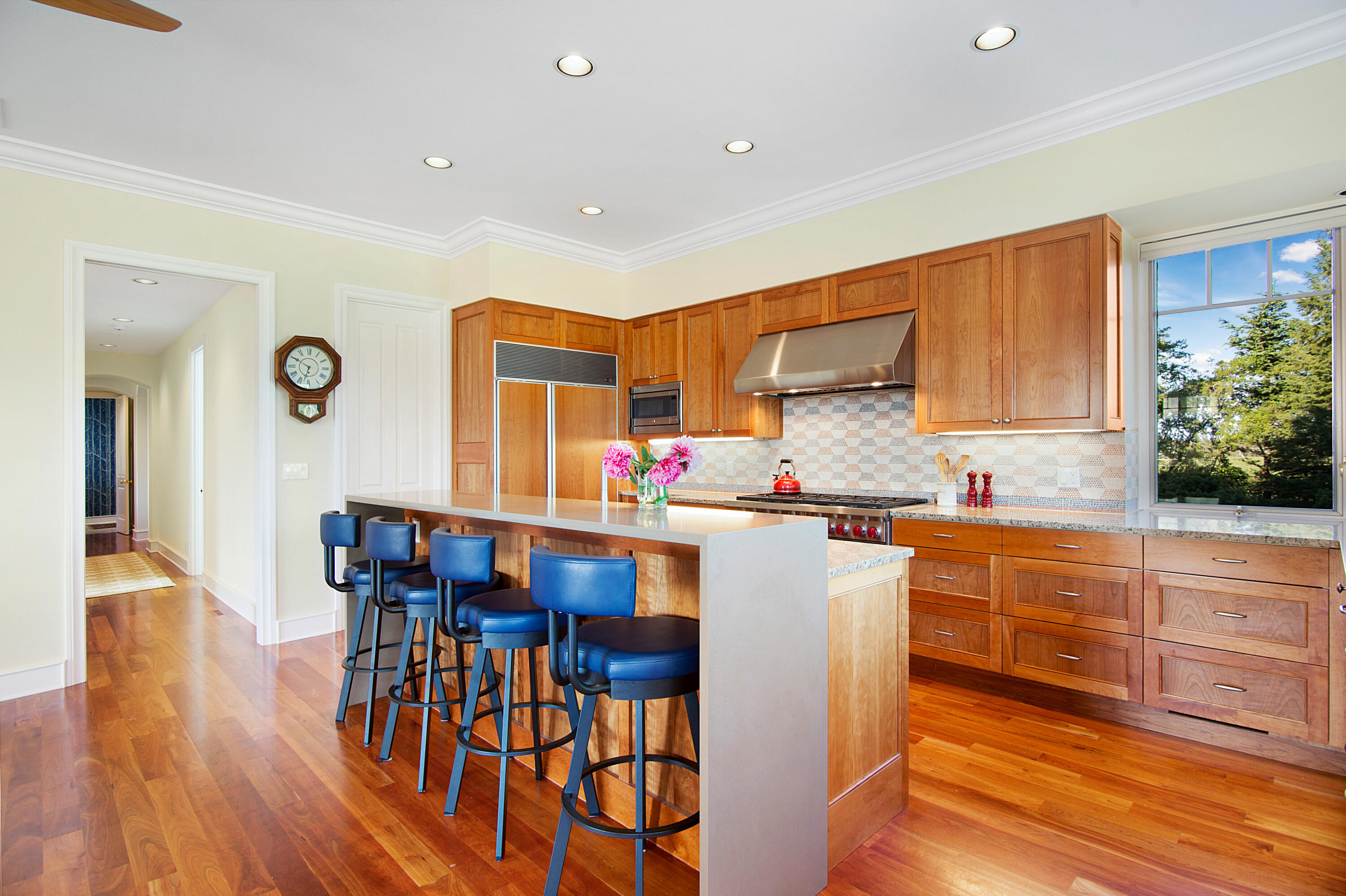 64950 Collins Road Bend, OR 97703 - Photo 18 of 87 a kitchen with granite countertop a table chairs stove and cabinets