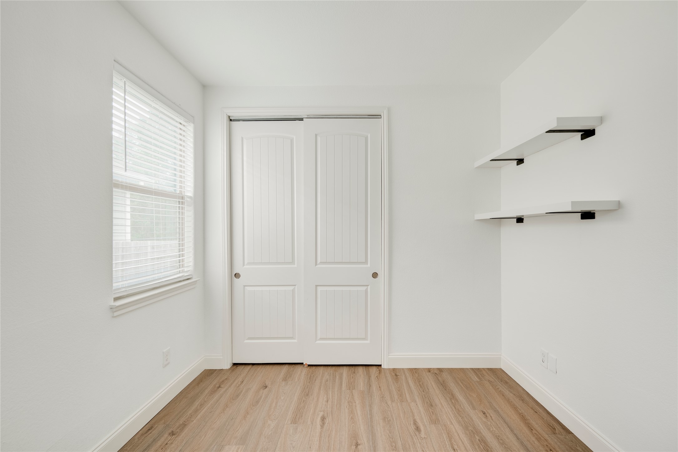 6008 Whipple Way Austin, TX 78745 - Photo 27 of 39 A well-lit room showcases smooth hardwood floors and ample storage with sliding closet doors.