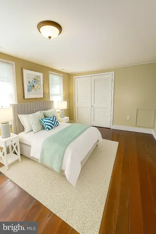 a bedroom with a large bed and a night stand