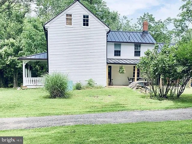a view of a house with a yard and plants