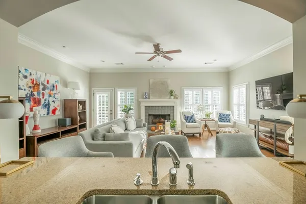 a living room with fireplace furniture and a chandelier
