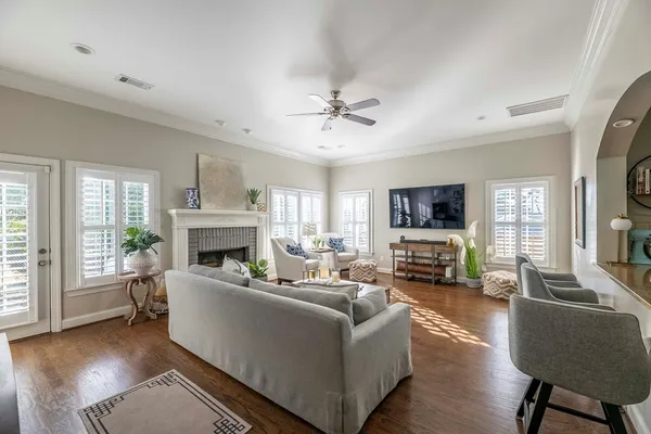 a living room with furniture a fireplace and a flat screen tv