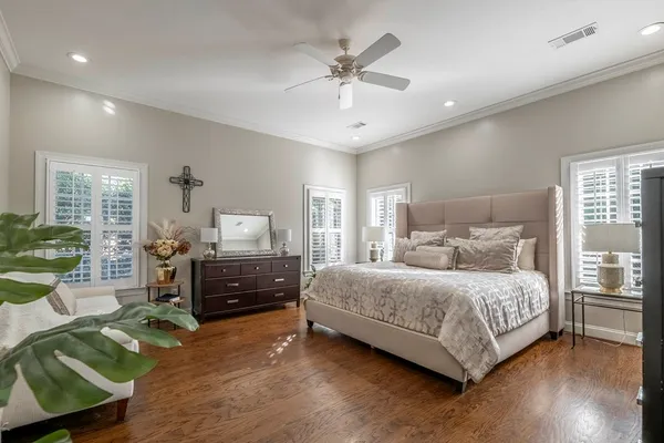 a bedroom with a bed and a large window