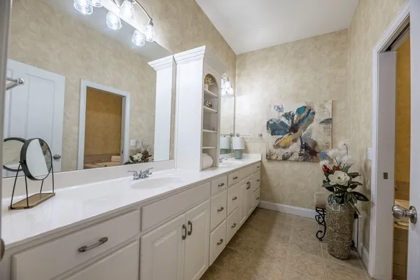 a bathroom with a granite countertop shower and a toilet