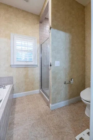 a bathroom with a shower a toilet and a sink