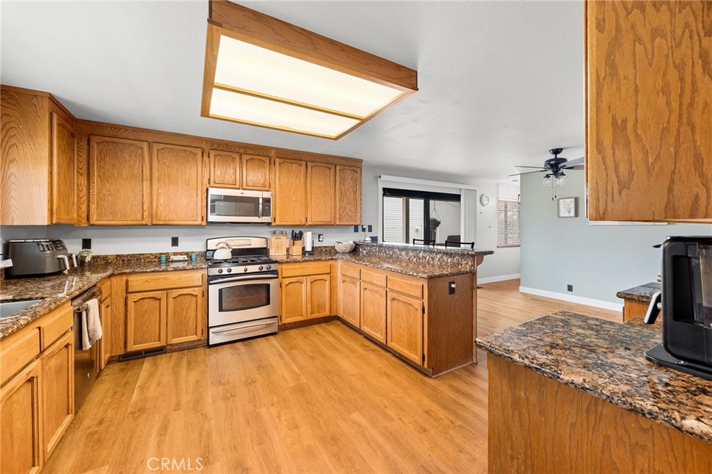 83 Gopher Road Oroville, CA 95966 - Photo 13 of 69 a kitchen with stainless steel appliances granite countertop a stove a sink dishwasher and a refrigerator