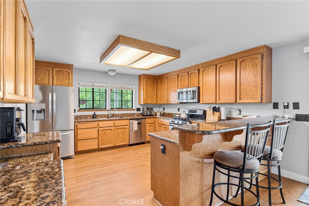 83 Gopher Road Oroville, CA 95966 - Photo 15 of 69 a kitchen with appliances a sink cabinets and a window
