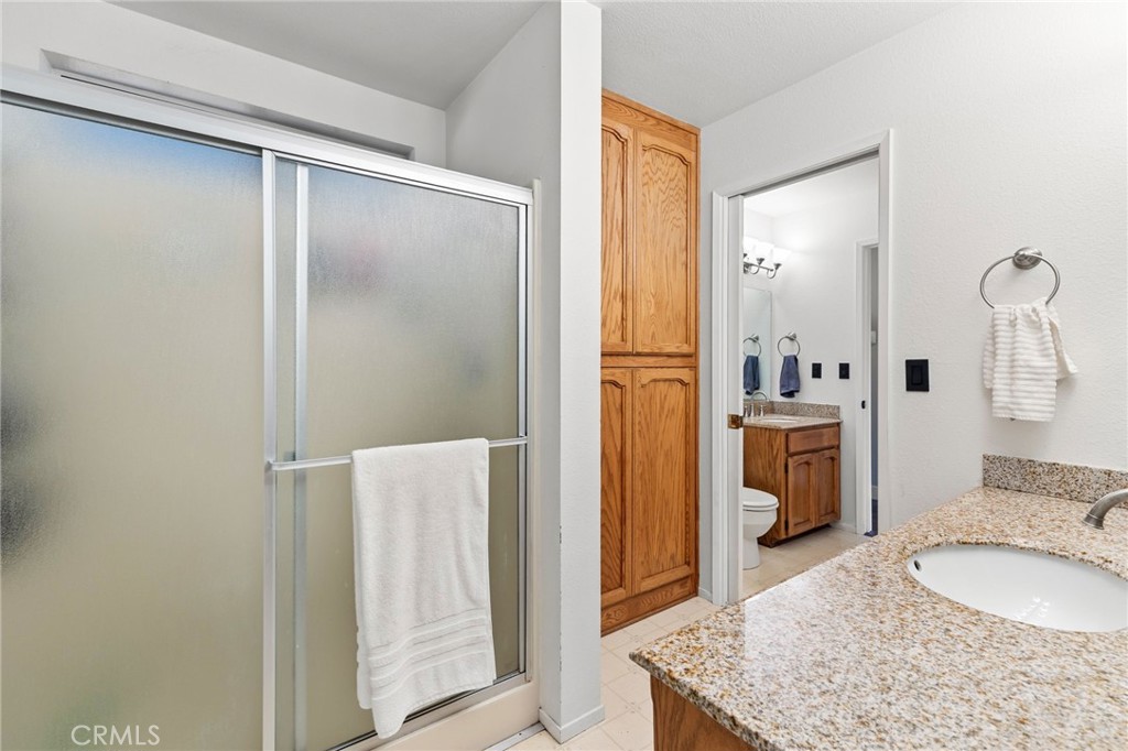 83 Gopher Road Oroville, CA 95966 - Photo 29 of 69 a bathroom with a granite countertop sink and a mirror