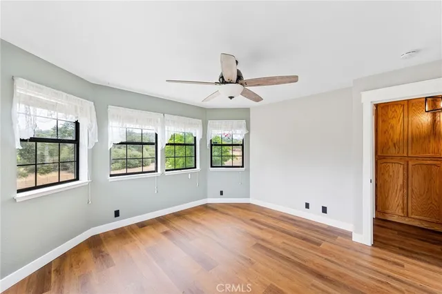 a kitchen with a wooden floor cabinets and a window