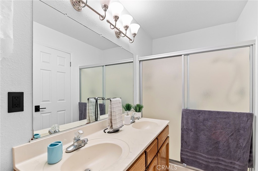 83 Gopher Road Oroville, CA 95966 - Photo 42 of 69 a bathroom with a granite countertop sink a mirror and shower