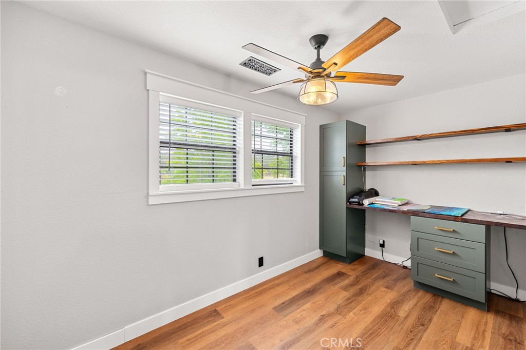 83 Gopher Road Oroville, CA 95966 - Photo 47 of 69 a kitchen with a wooden floor cabinets and a window