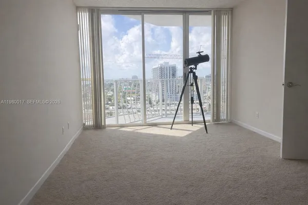 a view of an empty room with windows