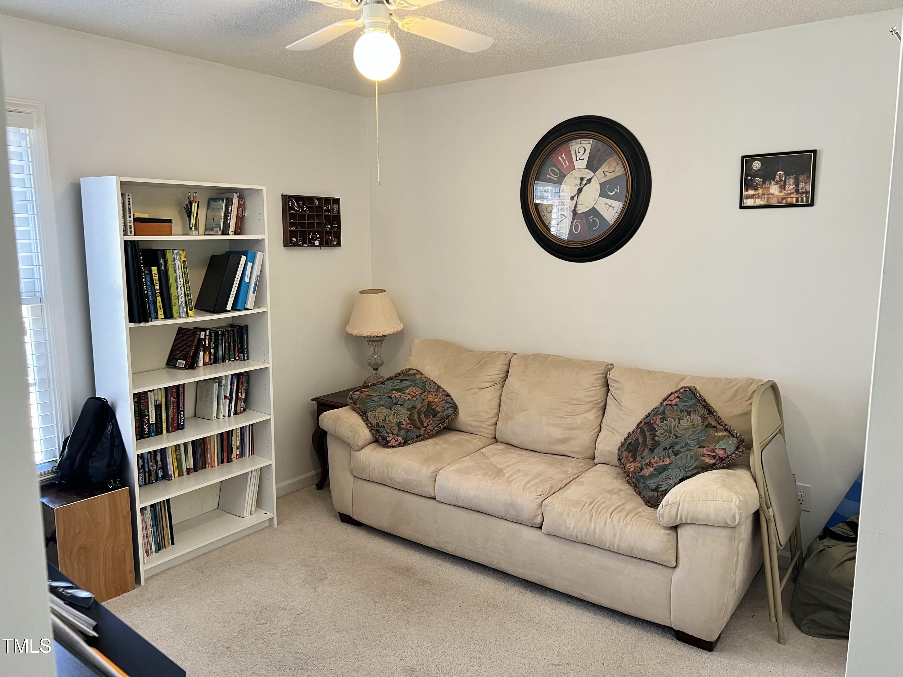 7709 Harps Mill Woods Run Raleigh, NC 27615 - Photo 11 of 15 a living room with furniture and a book shelf