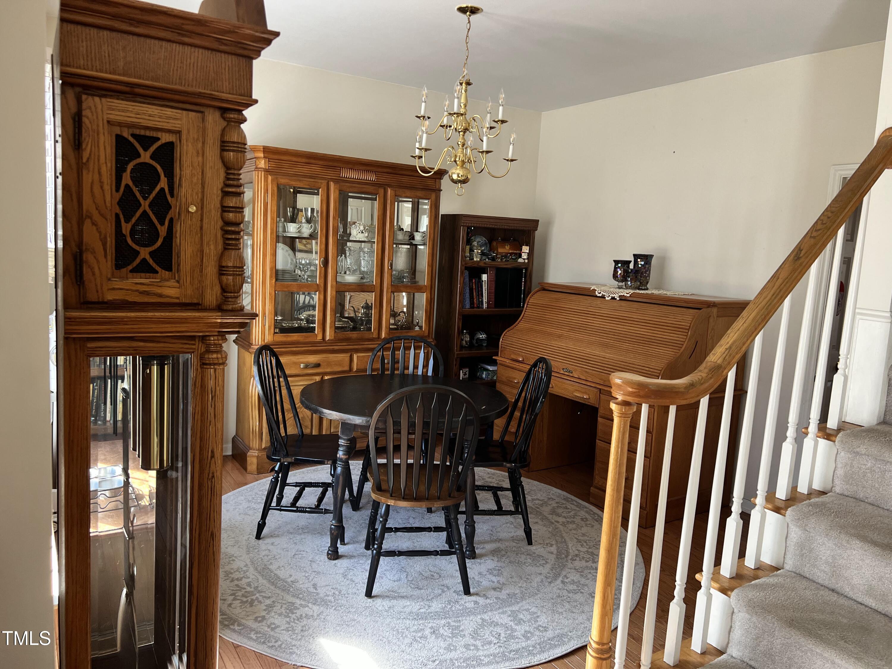 7709 Harps Mill Woods Run Raleigh, NC 27615 - Photo 3 of 15 a view of a dining room with furniture and chandelier