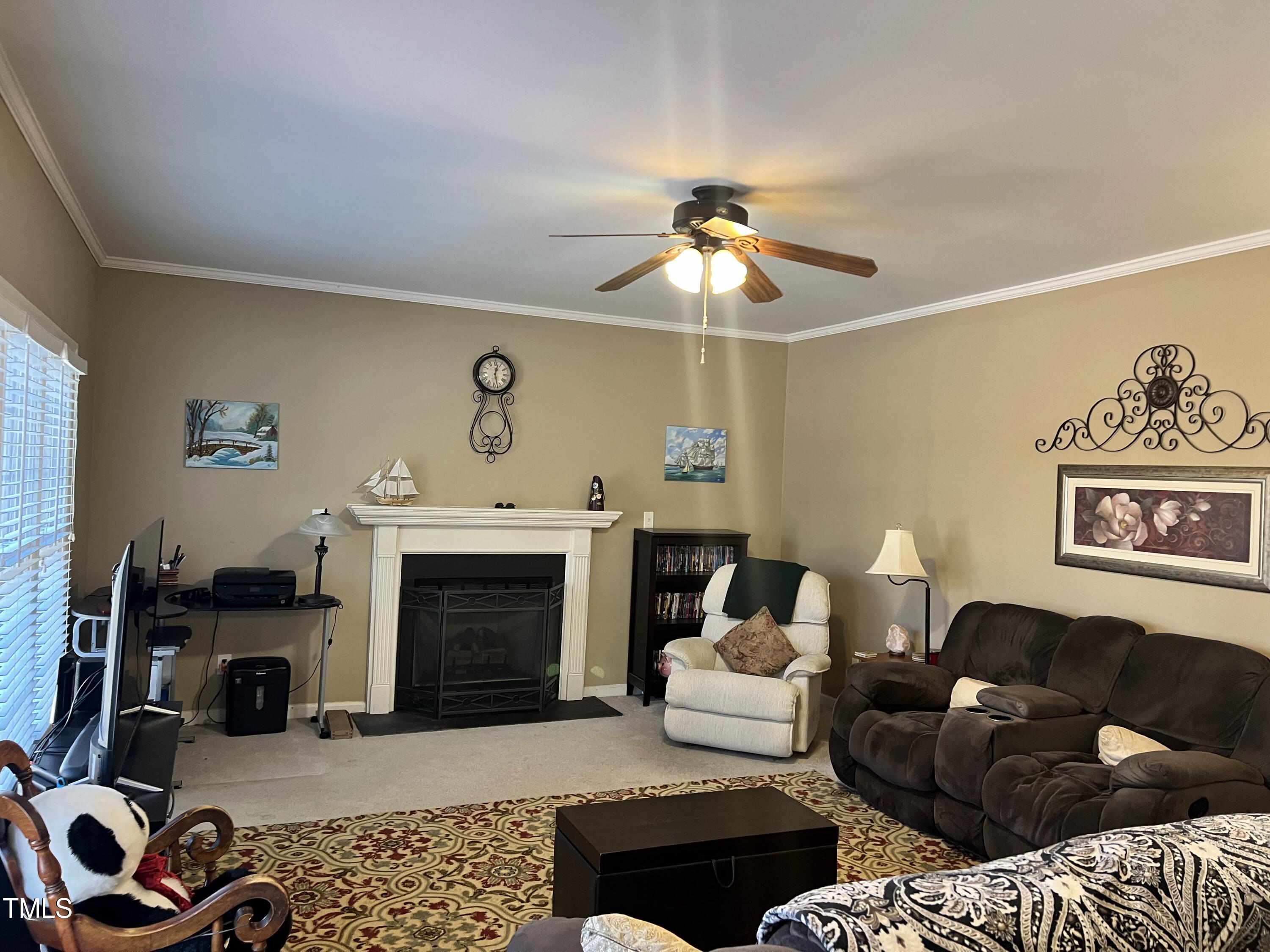 7709 Harps Mill Woods Run Raleigh, NC 27615 - Photo 4 of 15 a living room with furniture and a fireplace