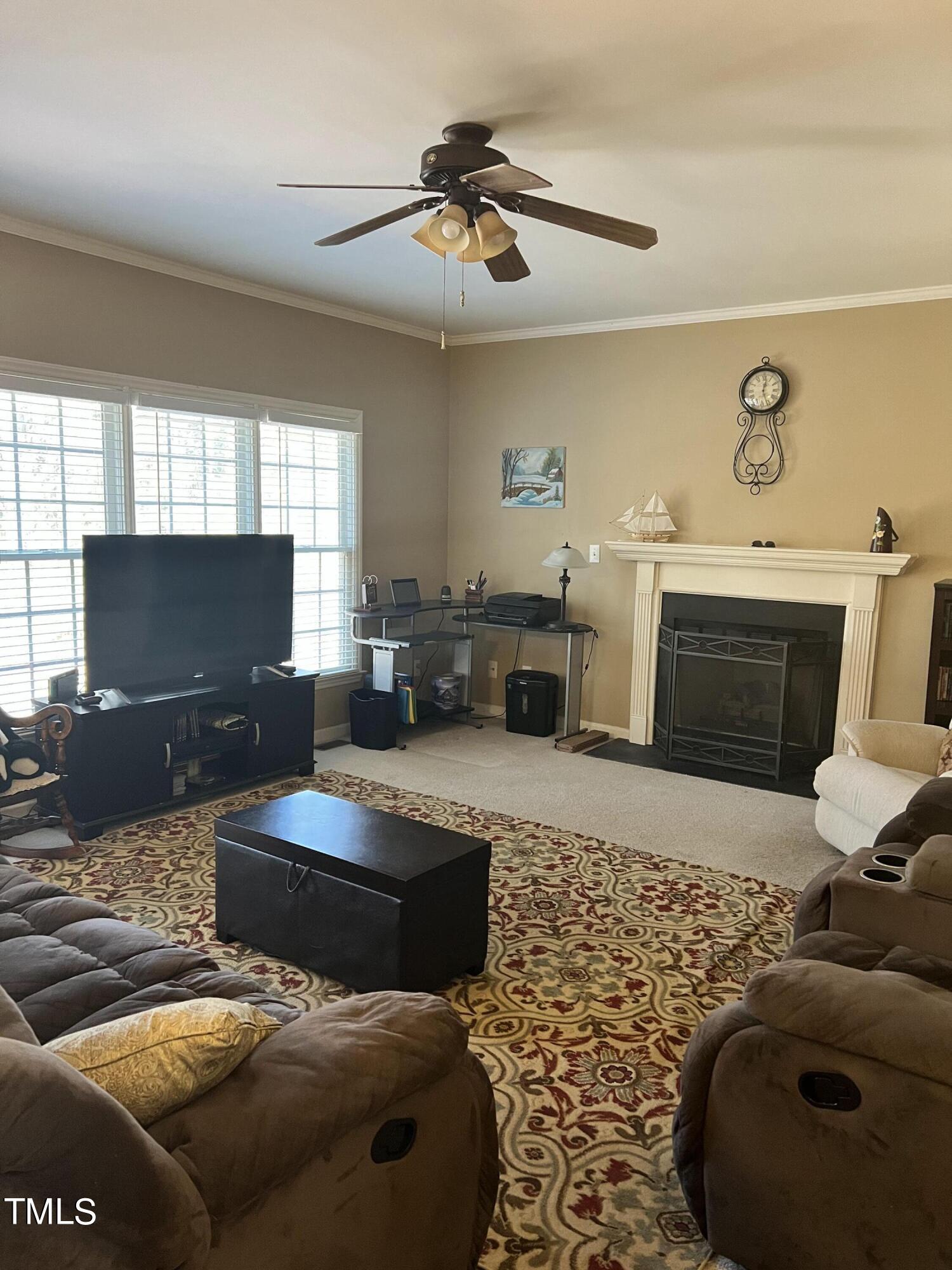7709 Harps Mill Woods Run Raleigh, NC 27615 - Photo 5 of 15 a living room with furniture and a fireplace