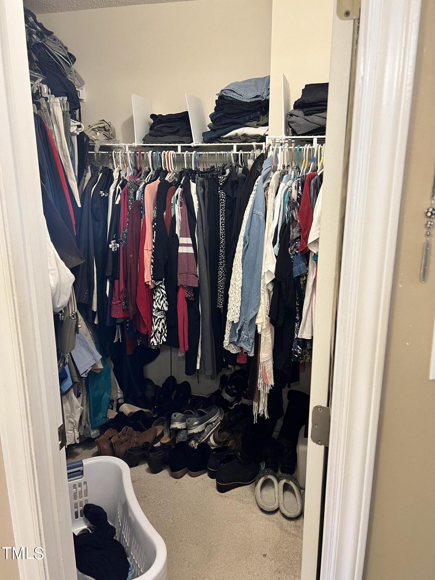 7709 Harps Mill Woods Run Raleigh, NC 27615 - Photo 9 of 15 a view of walk in closet with clothes and shoes