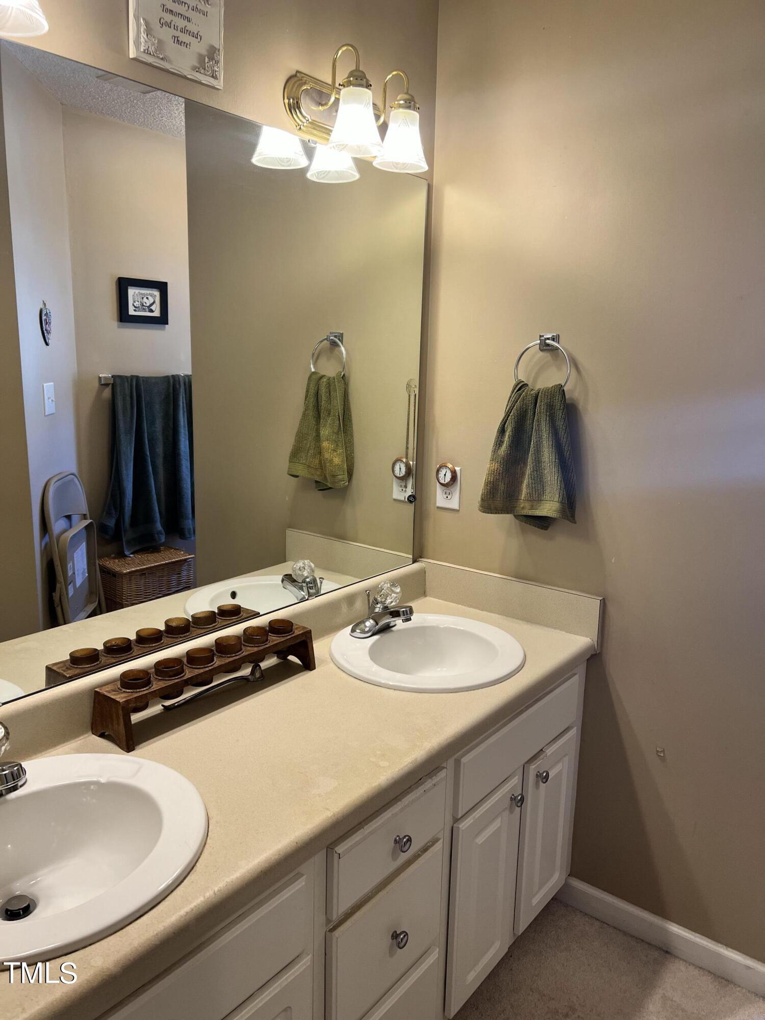 7709 Harps Mill Woods Run Raleigh, NC 27615 - Photo 10 of 15 a bathroom with a sink and a mirror