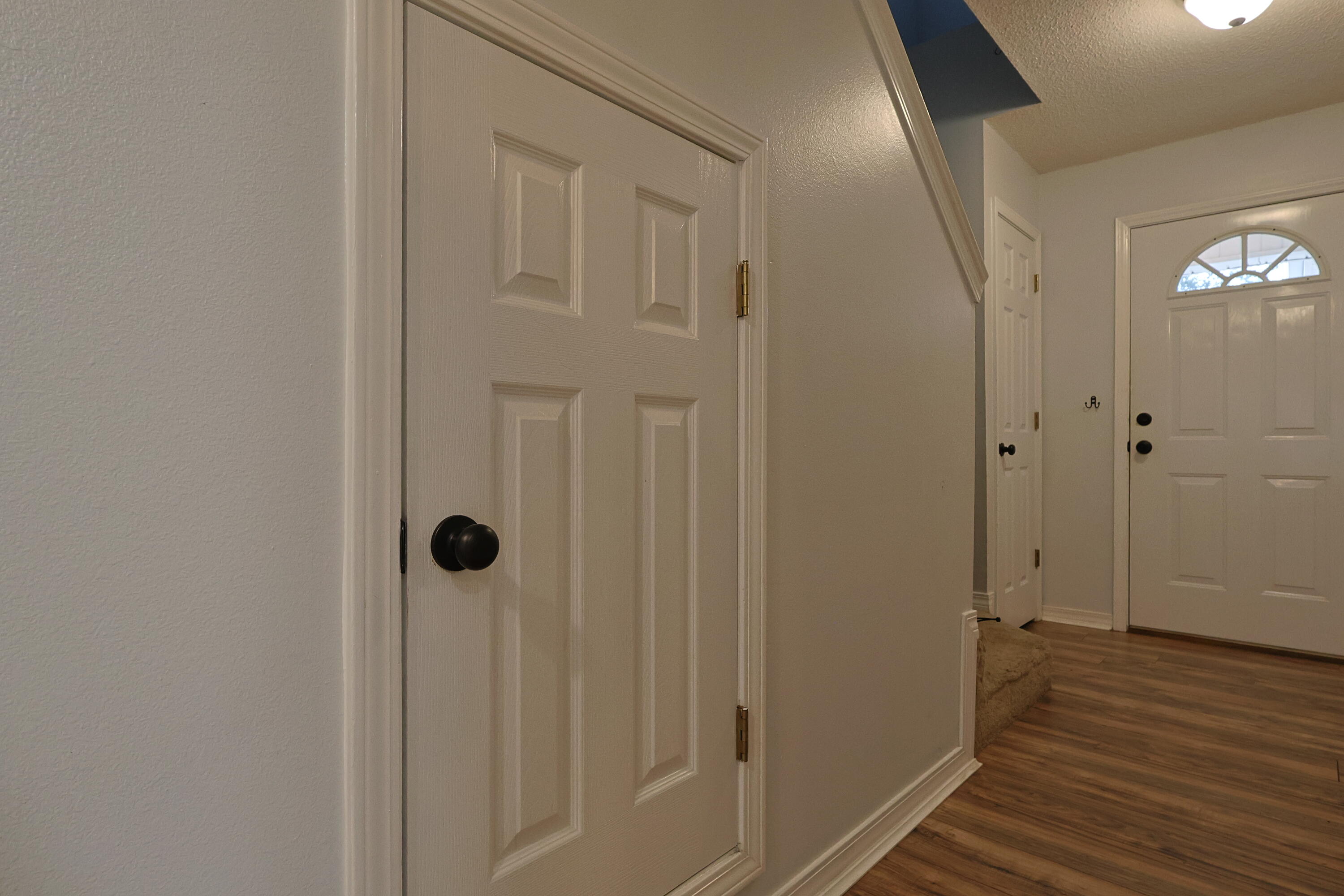 487 Keystone Road Mary Esther, FL 32569 - Photo 12 of 35 a view of a hallway with wooden floor and a bathroom
