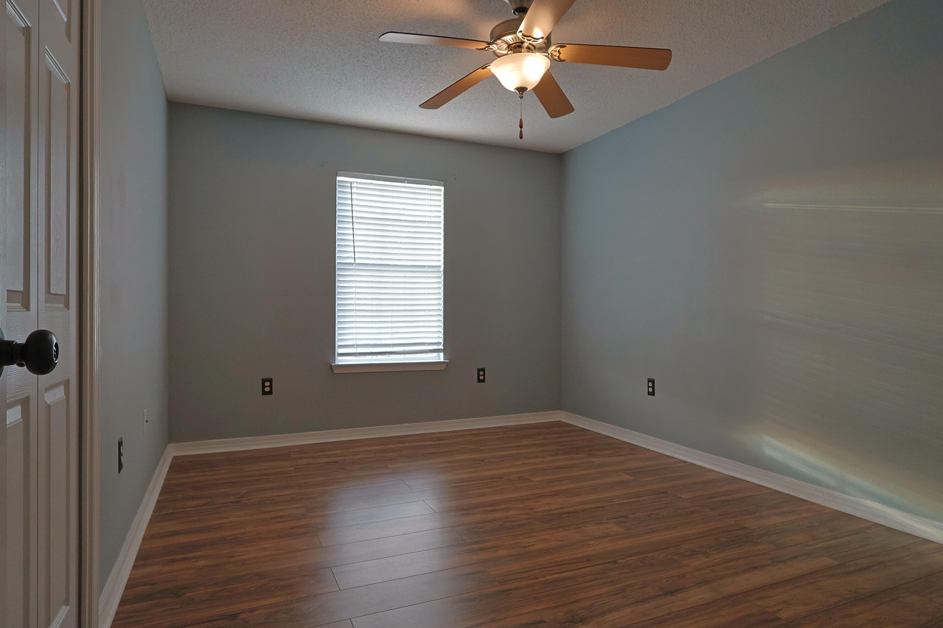 487 Keystone Road Mary Esther, FL 32569 - Photo 17 of 35 wooden floor in an empty room with a window