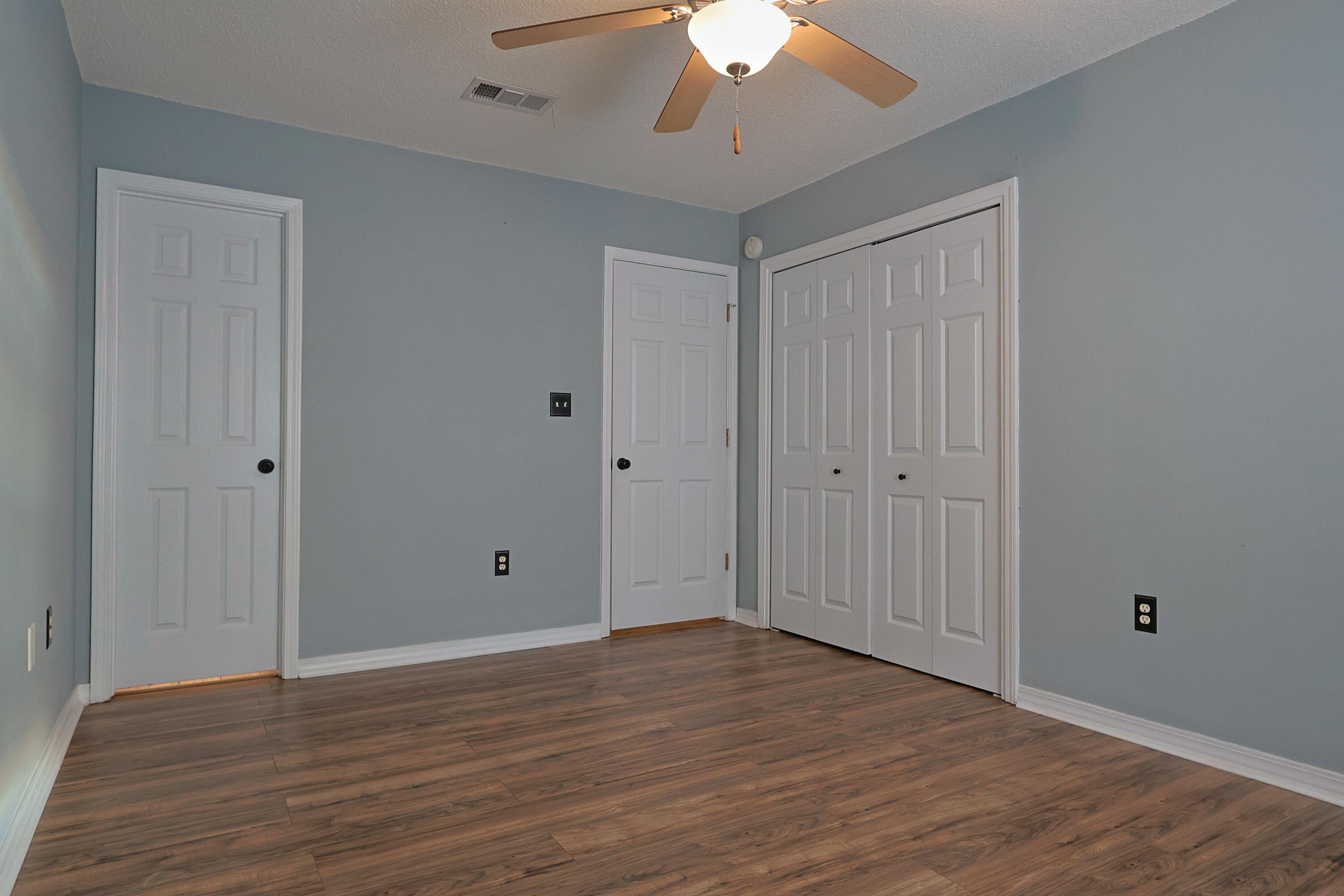 487 Keystone Road Mary Esther, FL 32569 - Photo 18 of 35 a view of an empty room with wooden floor