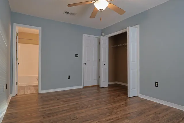 a view of an empty room with wooden floor