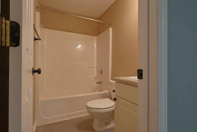 a bathroom with a toilet and a shower