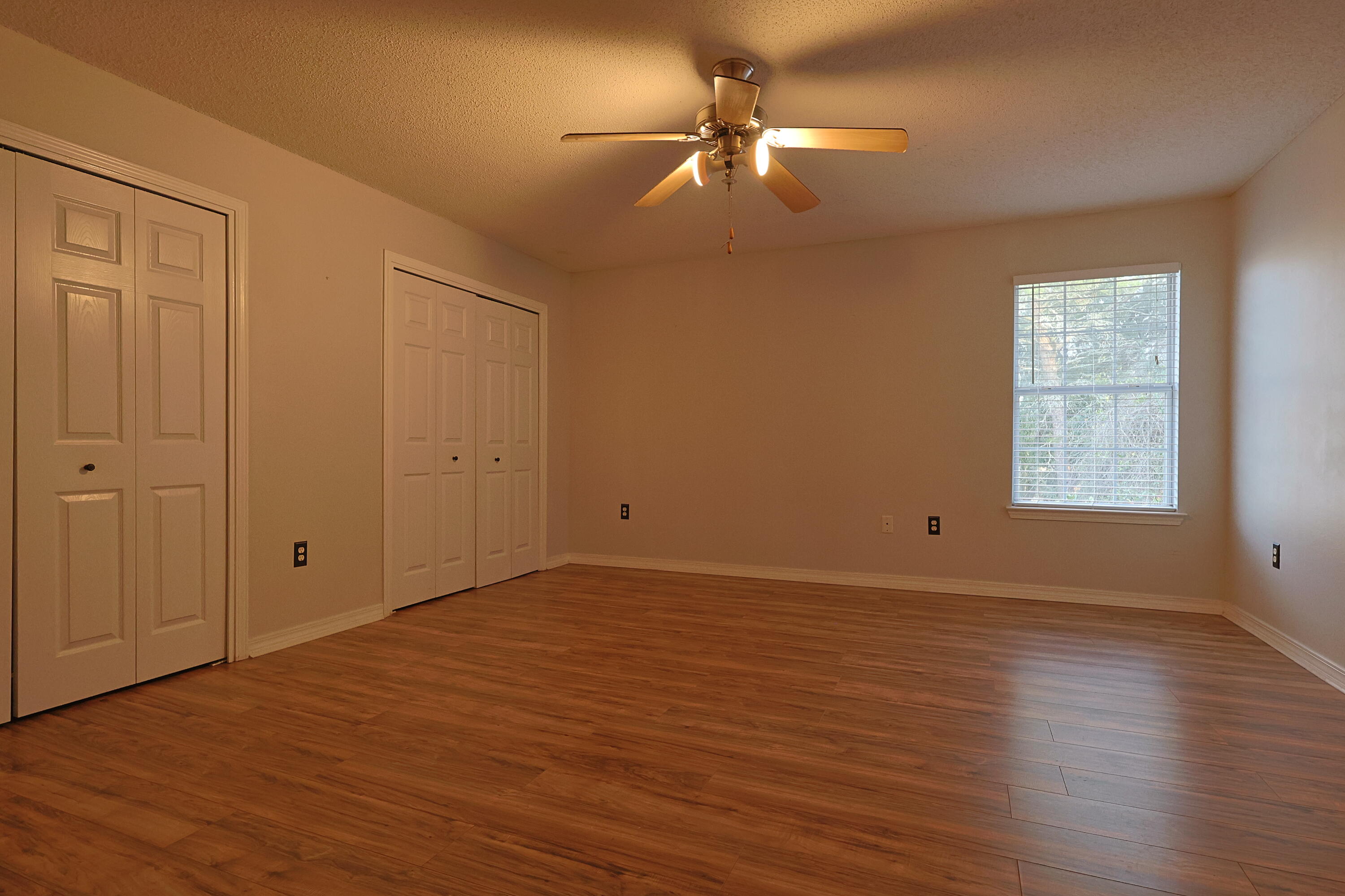 487 Keystone Road Mary Esther, FL 32569 - Photo 22 of 35 wooden floor in an empty room with a window