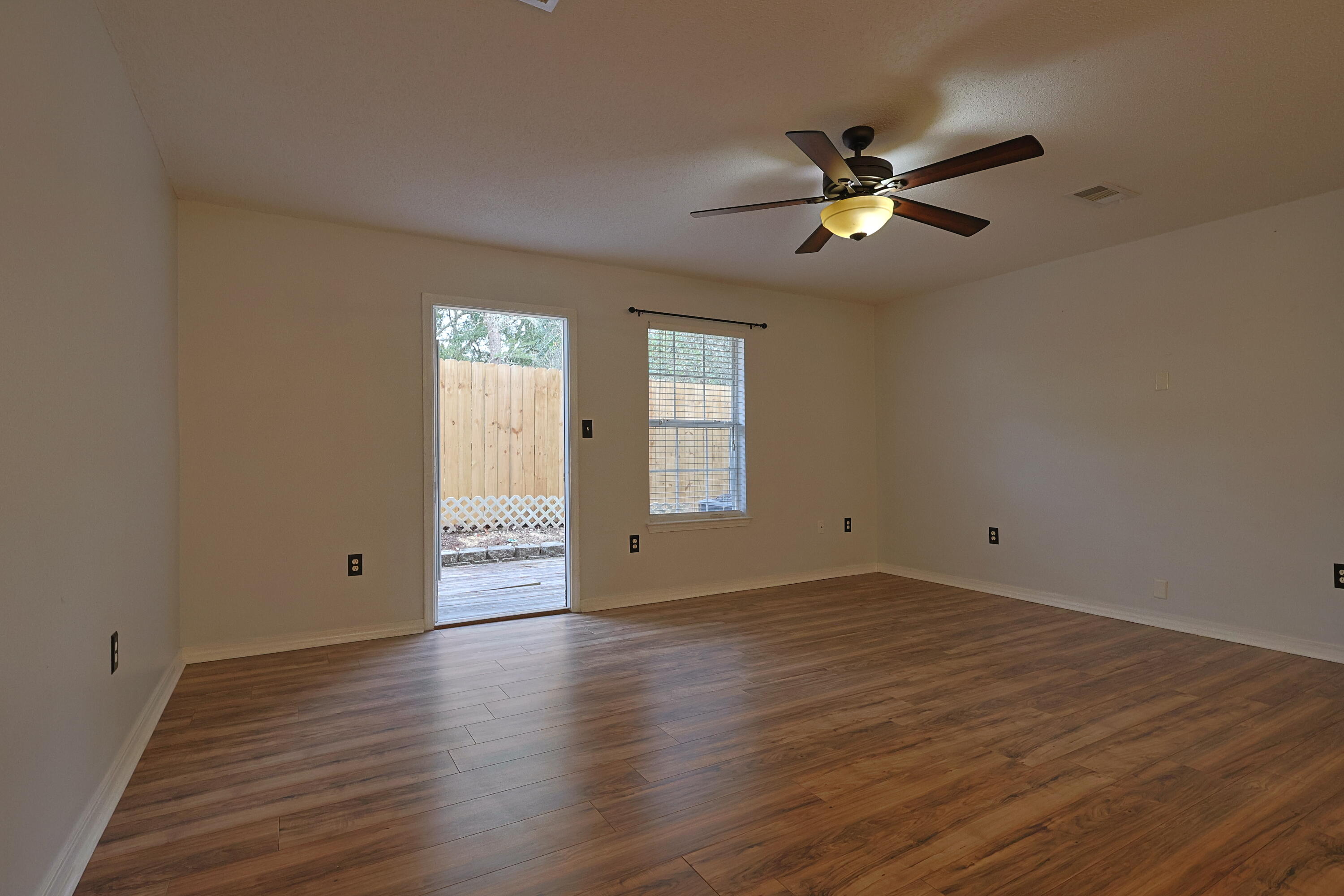 487 Keystone Road Mary Esther, FL 32569 - Photo 7 of 35 a view of empty room with wooden floor and fan