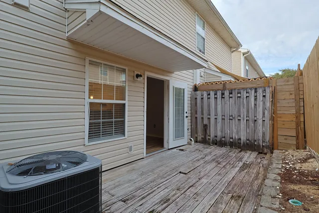 a view of a house with a wooden deck