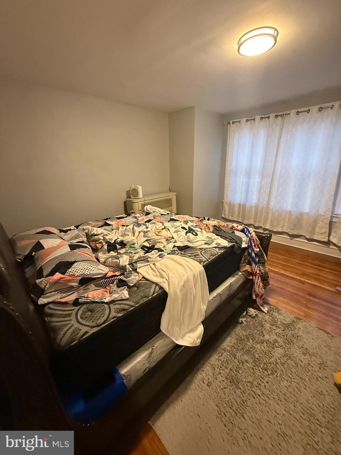 1861 South 65th Street Philadelphia, PA 19142 - Photo 12 of 31 a bed sitting in a bedroom next to a window