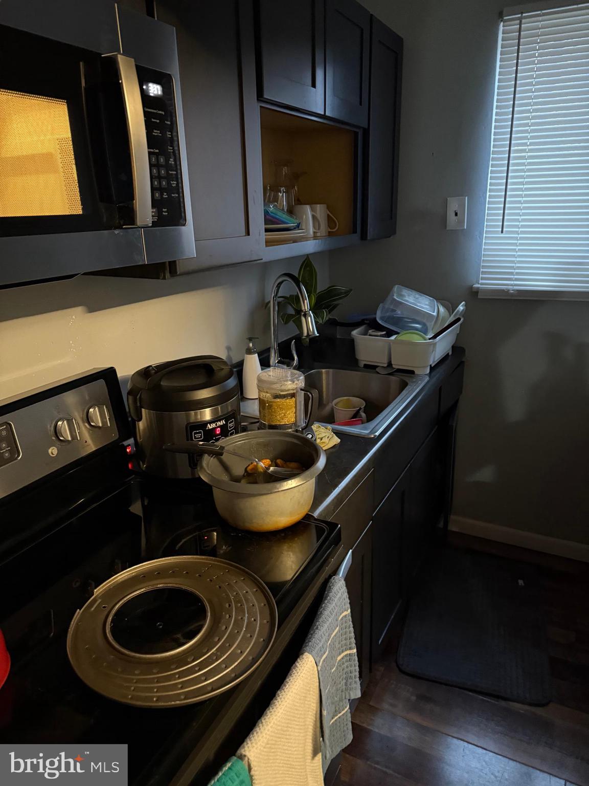 1861 South 65th Street Philadelphia, PA 19142 - Photo 24 of 31 a kitchen with a stove and a microwave