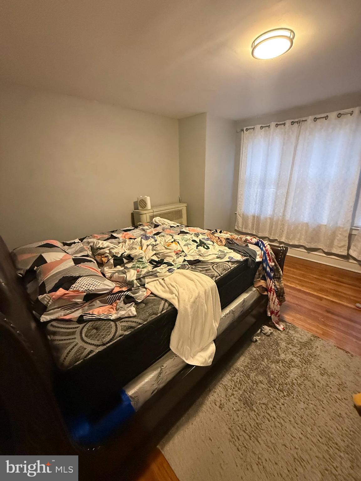1861 South 65th Street Philadelphia, PA 19142 - Photo 30 of 31 a bed sitting in a bedroom next to a window