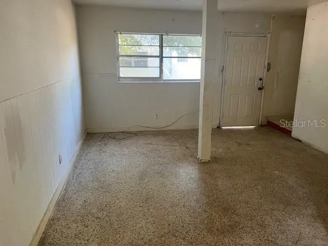 a view of staircase with white walls and railing