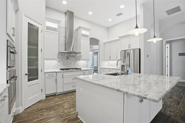 a white bath tub sitting in a bathroom next to a window