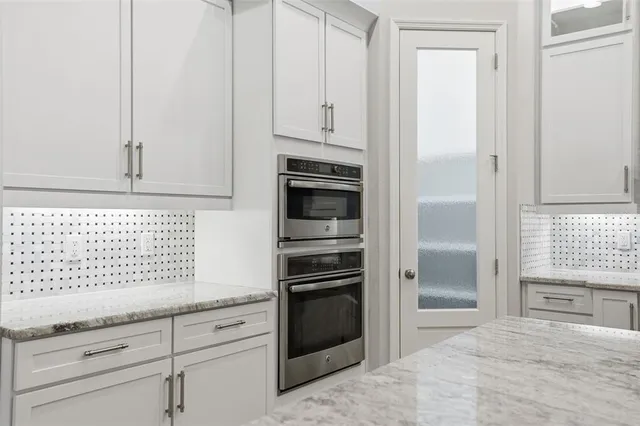 a bedroom with a large bed and a potted plant