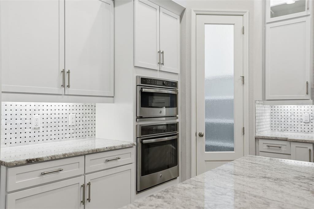 31999 Watoga Loop Wesley Chapel, FL 33543 - Photo 17 of 67 a kitchen with granite countertop white cabinets and stainless steel appliances
