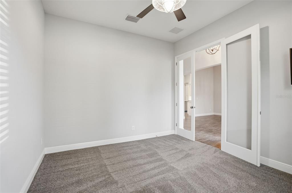 31999 Watoga Loop Wesley Chapel, FL 33543 - Photo 23 of 67 an empty room with a empty space and a ceiling fan