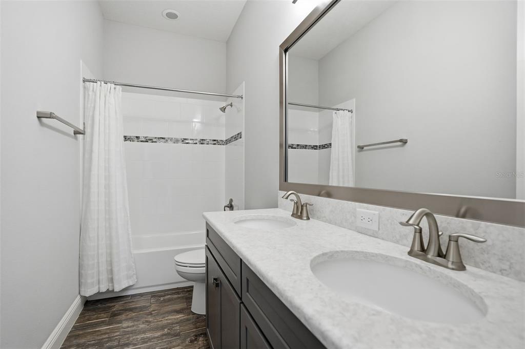 31999 Watoga Loop Wesley Chapel, FL 33543 - Photo 39 of 67 a bathroom with a granite countertop sink and a mirror