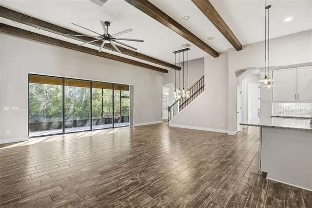 a kitchen with granite countertop white cabinets and stainless steel appliances