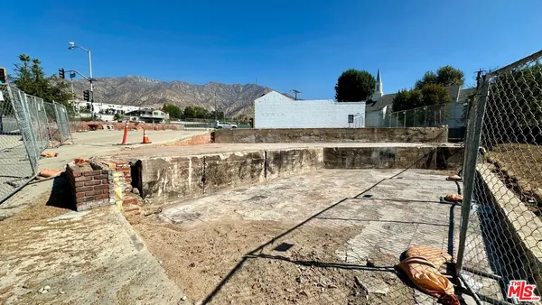 a view of a balcony with chairs and wooden floor