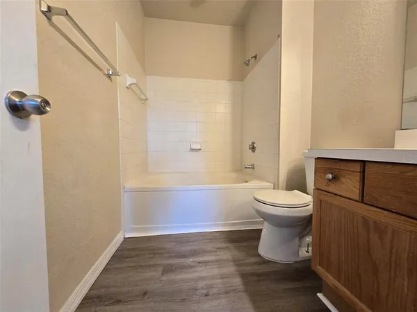 a bathroom with a toilet and shower