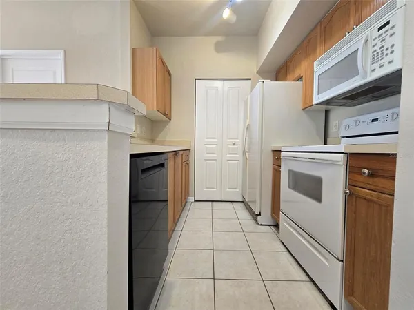 a kitchen with stainless steel appliances a refrigerator and cabinets