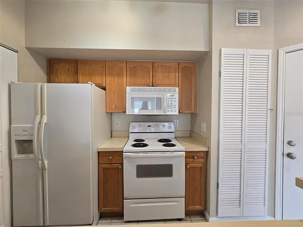 a kitchen with a stove and a refrigerator